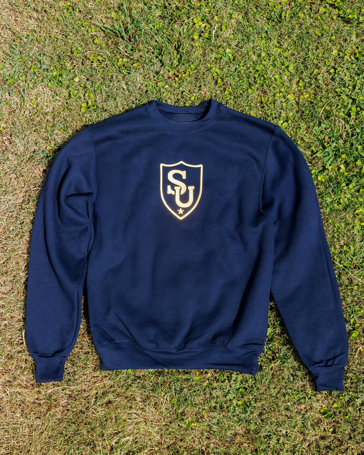 Sweeties University crewneck, navy with gold SU shield, front