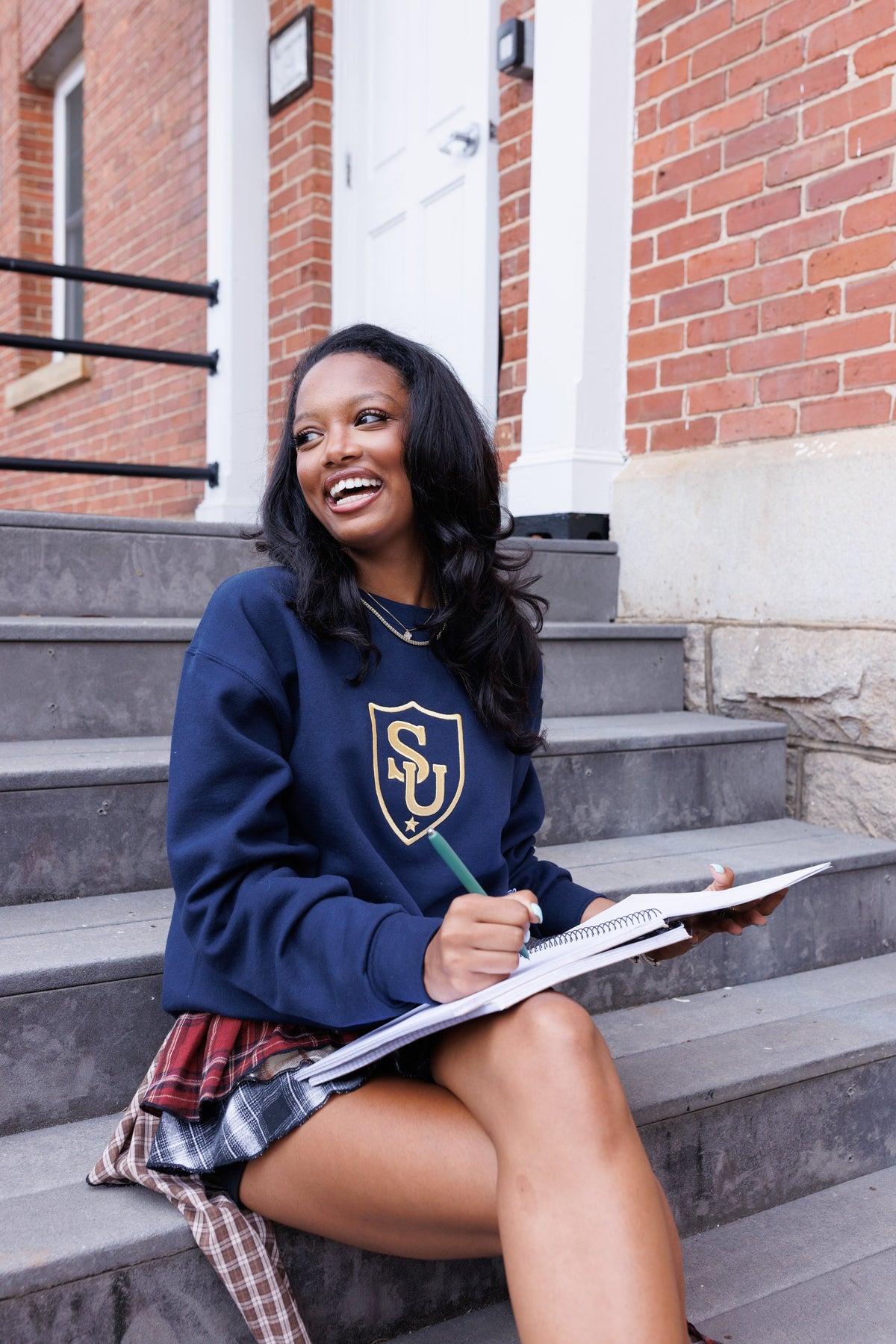 Sweeties University crewneck worn on campus steps