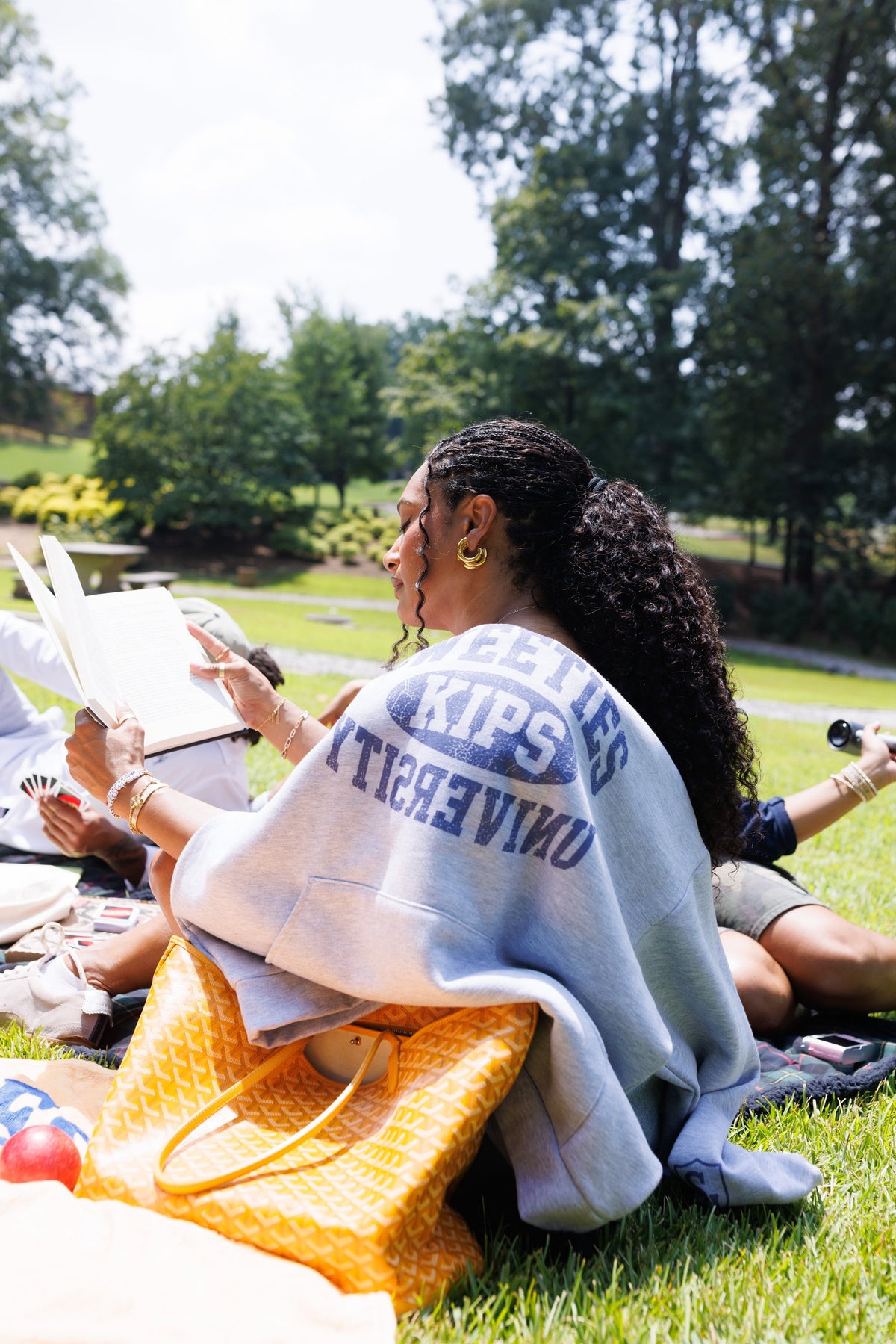 Sweeties University hoodie worn on the lawn